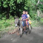 Biking tours in Cuba - Cute kids riding a donkey to El Salton