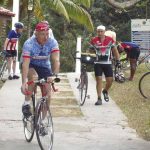 Group riding towards the gate - Aguas Claras cycling tour