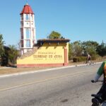 Cyclist arriving at town sign - Cayo - Trinidad